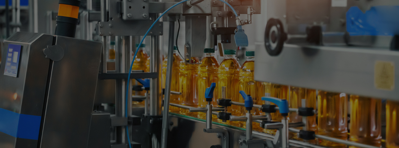 A machine is automatedly filling bottles in a production setting