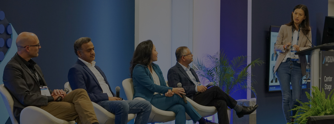  A group of people seated in chairs, engaged in discussion at a conference setting