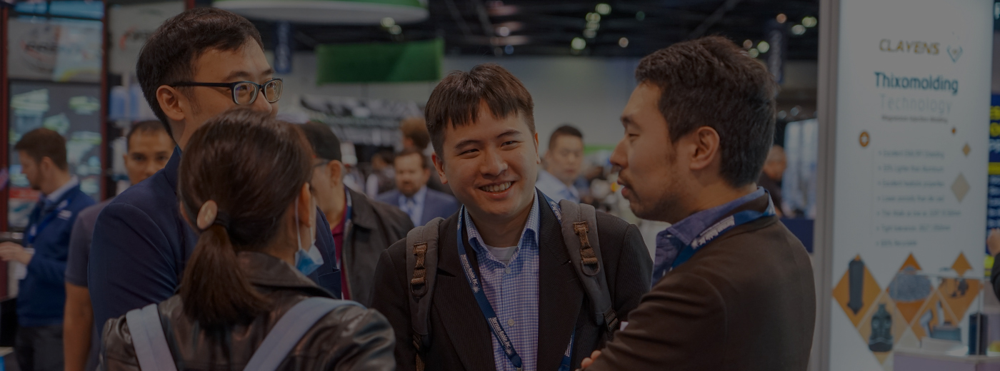 Attendees at an event are talking to one another, creating a dynamic environment filled with discussion and engagement