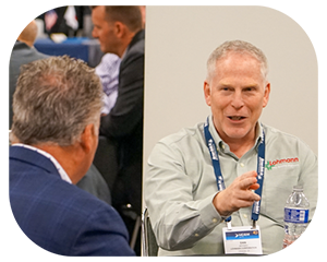 Two men engaged in conversation at a conference table, discussing ideas in a professional setting