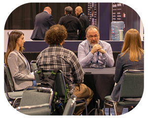  A diverse group of people engaged in conversation while sitting around a table