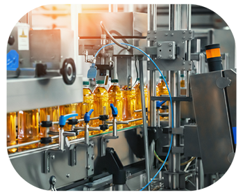 A factory machine is producing bottles on an assembly line