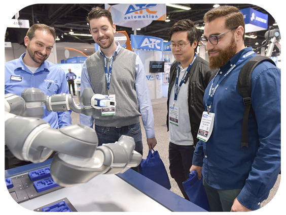 Three men observe a robot displayed at an exhibit, engaged in discussion about its features and technology