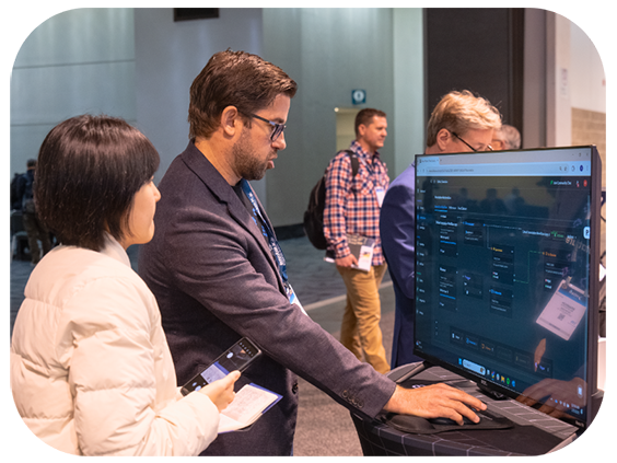  A man and woman are looking at a large table screen, appearing to collaborate or share insights