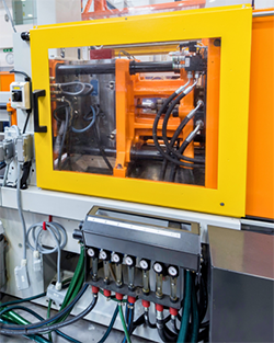 A machine designed for manufacturing plastic parts, showcasing its industrial components and operational setup