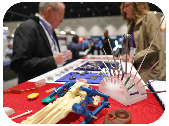 A man and woman examine a display of various medical equipment in a well-lit healthcare setting